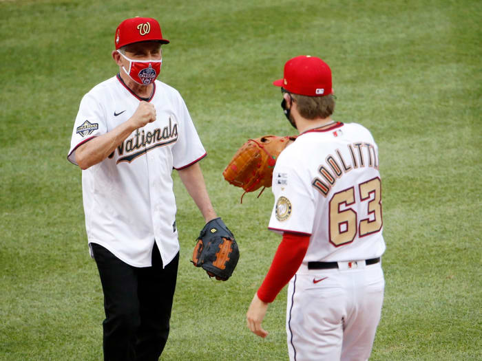 Jul 23, 2020; Washington, DC, USA; National Institute of of Allergy and Infectious Diseases director Dr. Anthony Fauci greets Washington Nationals relief pitcher Sean Doolittle (63) after throwing out the ceremonial first pitch before MLB Opening Day between the New York Yankees and the Washington Nationals at Nationals Park.